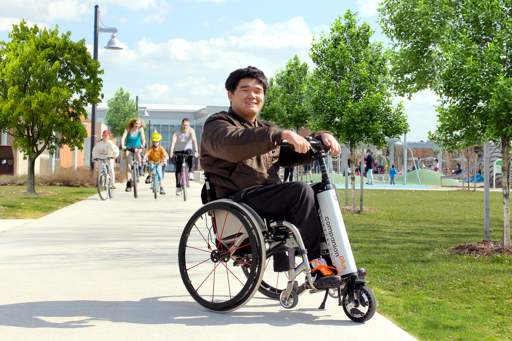 Companion power assist for manual wheelchairs